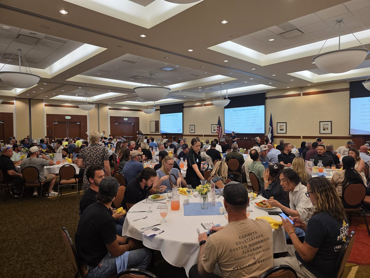 A large banquet hall filled with business owners attending a lethal means safety and mental health presentation.