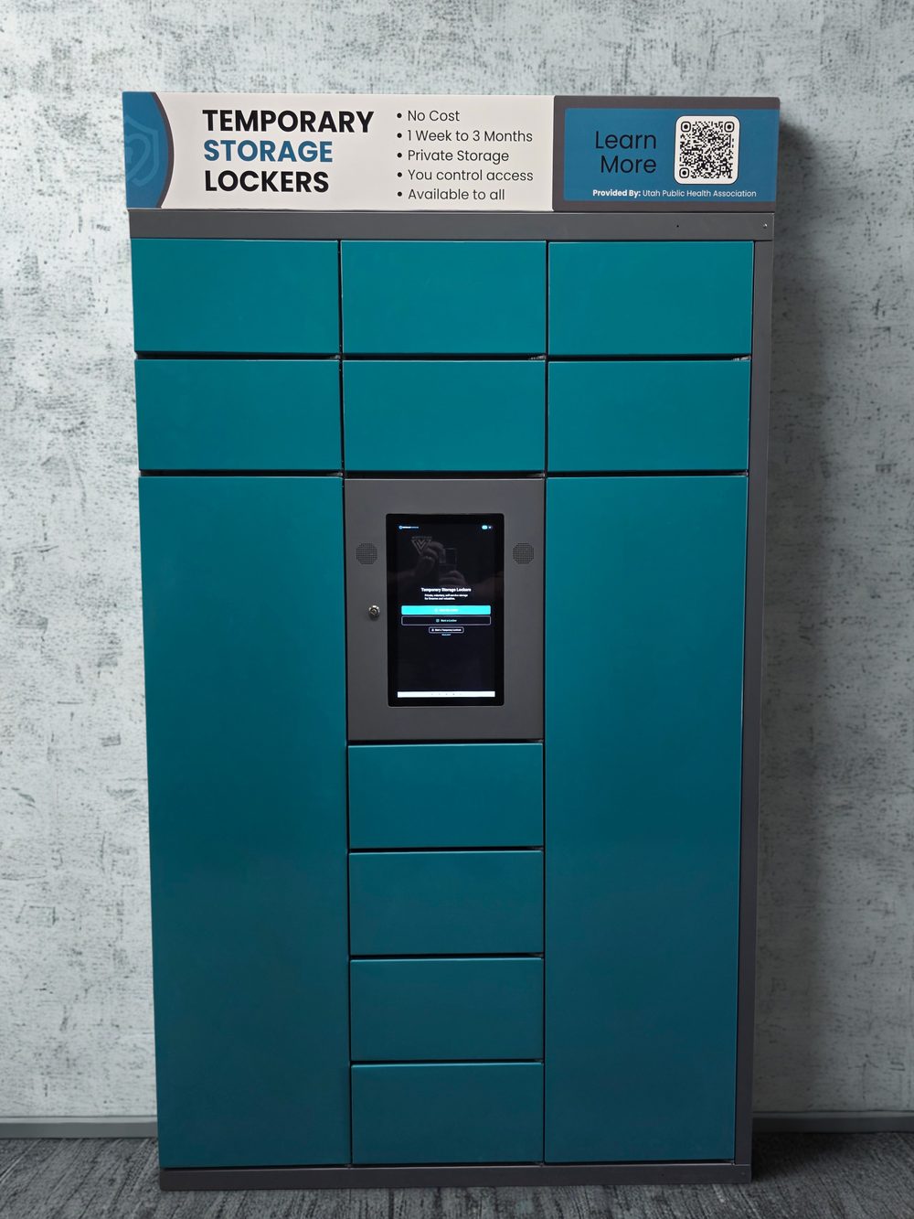 The standard SafeReach locker configuration: a teal steel locker bank with ten small compartments, two full-height rifle compartments and a central touchscreen kiosk.